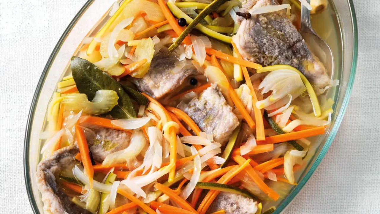 Piatto di pesce in carpione con verdure julienne, carote, zucchine e cipolle. Una deliziosa ricetta da provare.