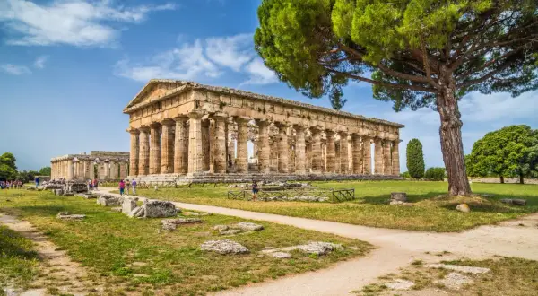 Antichi templi greci a Paestum, dove si trova questo sito archeologico patrimonio UNESCO, con visitatori che passeggiano tra le rovine.